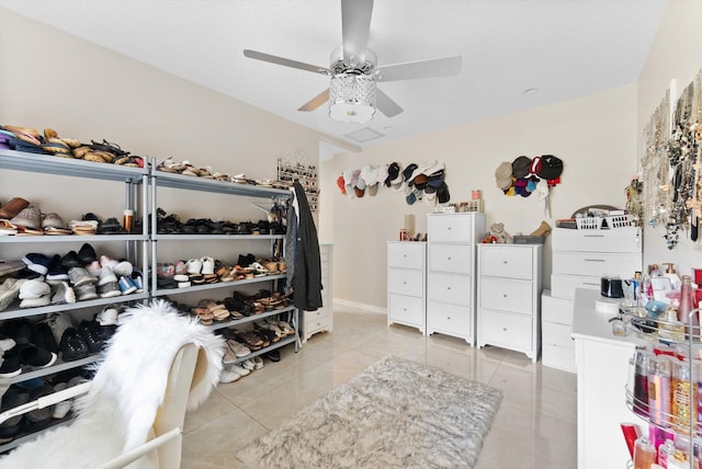 walk in closet featuring light tile patterned floors and a ceiling fan