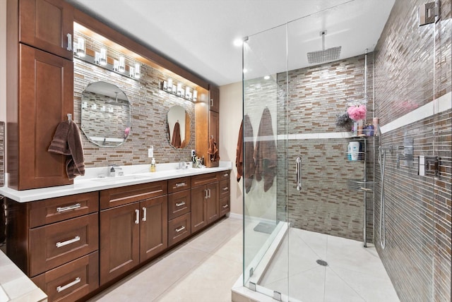 full bath featuring decorative backsplash, a sink, double vanity, a stall shower, and tile patterned flooring