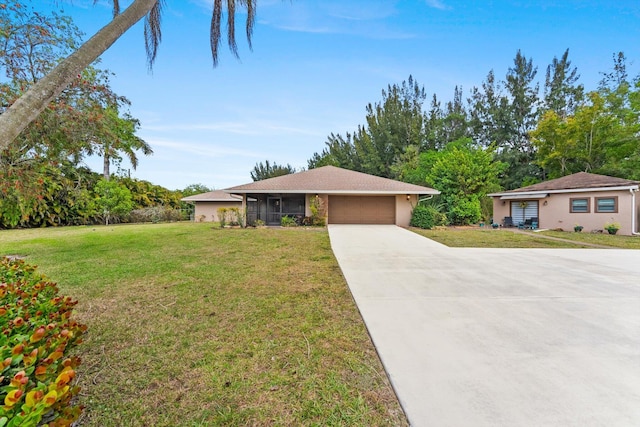 view of front of home featuring driveway, a front yard, a garage, and stucco siding