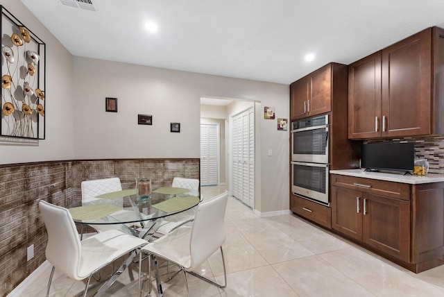 kitchen with recessed lighting, visible vents, backsplash, light countertops, and double oven