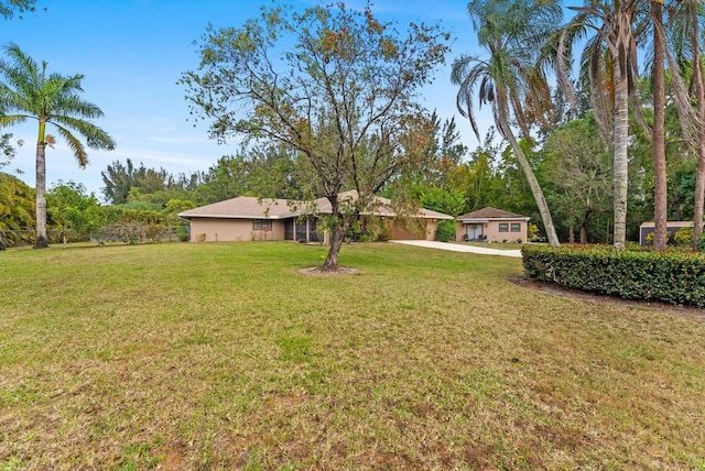 6028 140th Ave N, The Acreage, FL 33412 - view of green lawn featuring concrete driveway and a carport