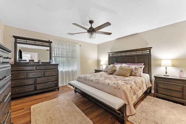bedroom with visible vents, wood finished floors, and a ceiling fan