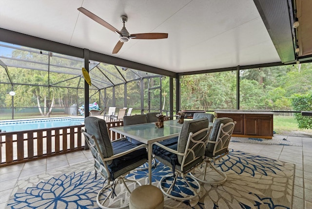 view of patio featuring an outdoor pool, a ceiling fan, glass enclosure, and outdoor dining area
