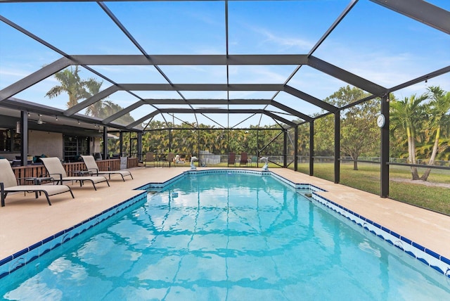 pool with a lanai and a patio area