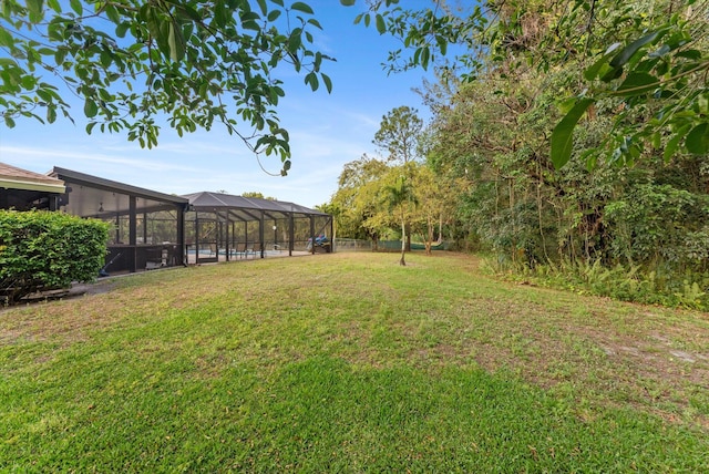 view of yard with glass enclosure
