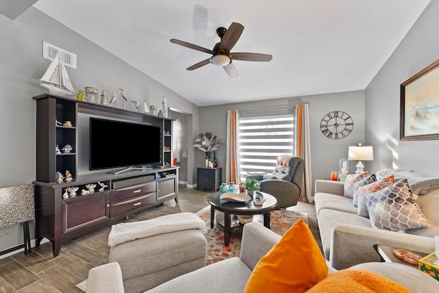 living area with wood finished floors, vaulted ceiling, baseboards, visible vents, and a ceiling fan