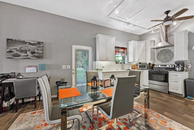 6028 140th Ave N, The Acreage, FL 33412 - kitchen featuring stainless steel range with electric cooktop, wall chimney exhaust hood, dark wood-style floors, a ceiling fan, and a textured ceiling