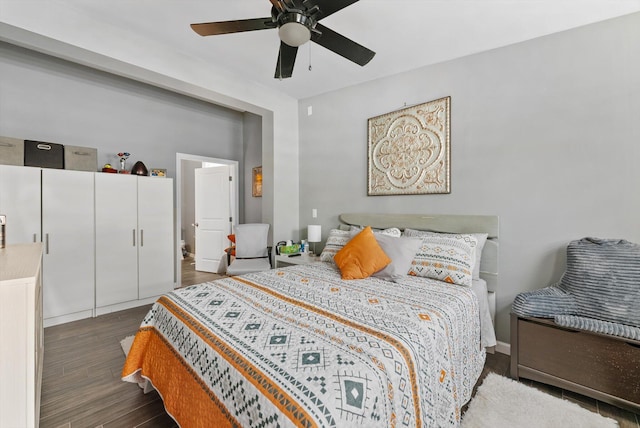 bedroom with ceiling fan, wood finished floors, and baseboards