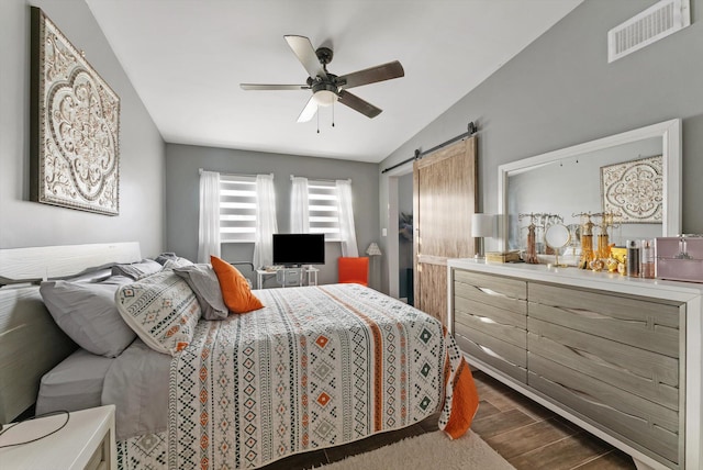 6028 140th Ave N, The Acreage, FL 33412 - bedroom with a barn door, vaulted ceiling, dark wood-type flooring, and a ceiling fan