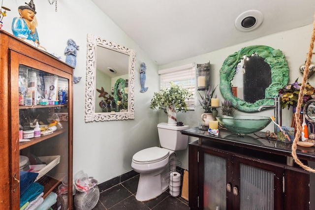 1894 NW Britt Rd, Stuart, FL 34994 - half bath with vaulted ceiling, toilet, vanity, and baseboards