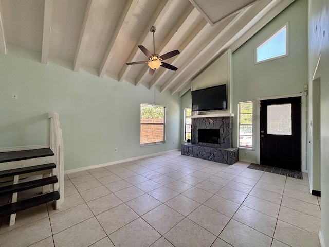 1894 NW Britt Rd, Stuart, FL 34994 - unfurnished living room featuring high vaulted ceiling, a fireplace, a ceiling fan, beamed ceiling, and light tile patterned floors