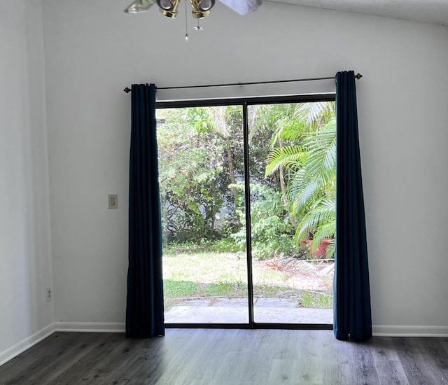 doorway with baseboards, a ceiling fan, and wood finished floors