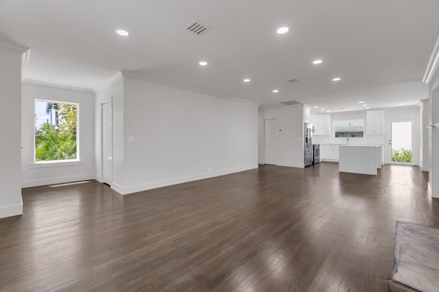 4015 Washington Rd, West Palm Beach, FL 33405 - unfurnished living room with ornamental molding, baseboards, recessed lighting, and visible vents