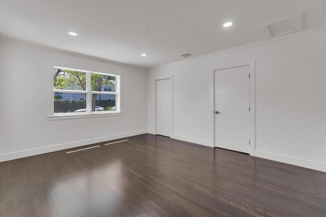 4015 Washington Rd, West Palm Beach, FL 33405 - unfurnished bedroom with crown molding, visible vents, wood finished floors, attic access, and baseboards