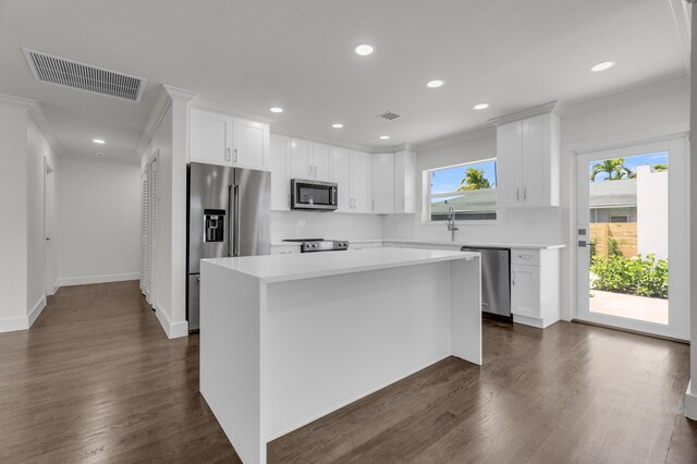 4015 Washington Rd, West Palm Beach, FL 33405 - kitchen with crown molding, appliances with stainless steel finishes, and visible vents