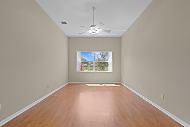 empty room with baseboards, visible vents, light wood-style flooring, and ceiling fan
