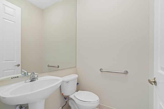 bathroom with toilet and a sink