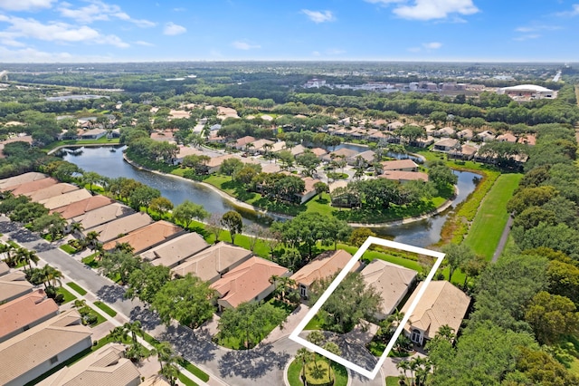drone / aerial view with a residential view and a water view