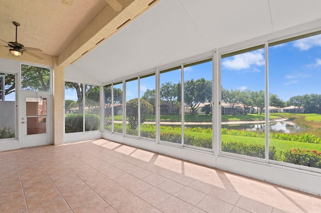 unfurnished sunroom featuring a ceiling fan and a water view