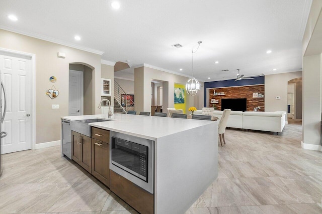 kitchen with built in microwave, arched walkways, dishwasher, and a ceiling fan