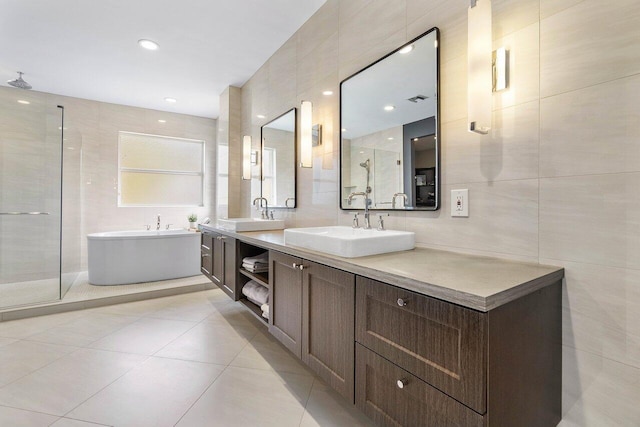 full bath featuring tile walls, a sink, and a stall shower