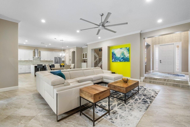 living area featuring ornamental molding, baseboards, a ceiling fan, and recessed lighting