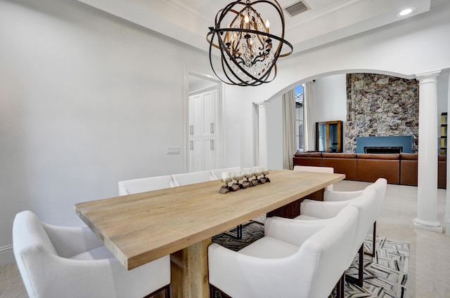 9210 Equus Cir, Boynton Beach, FL 33472 - dining area featuring decorative columns, arched walkways, a chandelier, recessed lighting, and a fireplace