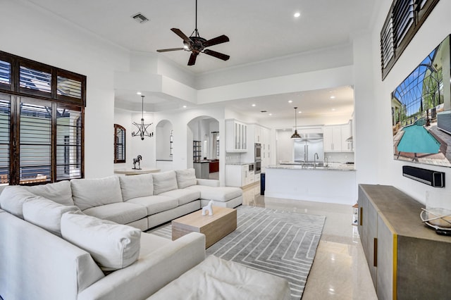 9210 Equus Cir, Boynton Beach, FL 33472 - living room with arched walkways, a ceiling fan, recessed lighting, crown molding, and light marble finish floors