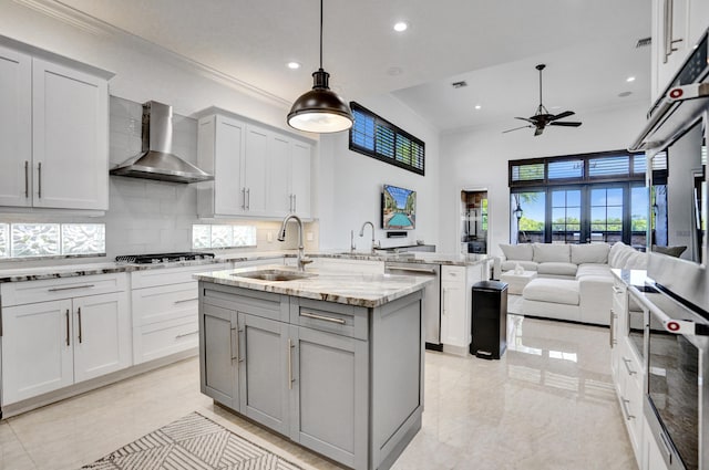 9210 Equus Cir, Boynton Beach, FL 33472 - kitchen featuring wall chimney exhaust hood, gray cabinets, a sink, a ceiling fan, and stainless steel appliances