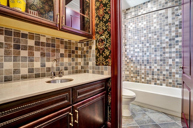 9210 Equus Cir, Boynton Beach, FL 33472 - bathroom featuring toilet, vanity, tasteful backsplash, tile patterned floors, and shower / bathtub combination