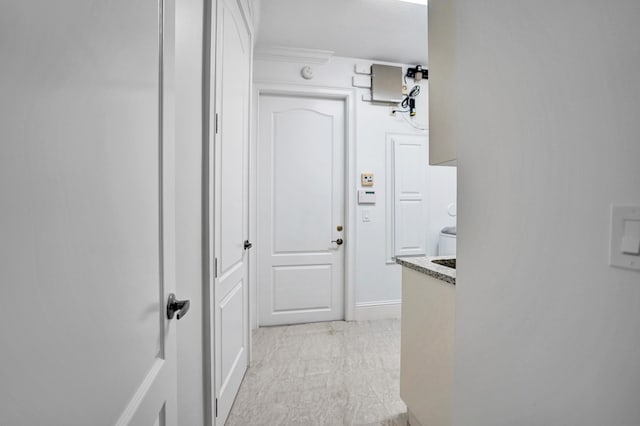 corridor with baseboards and ornamental molding
