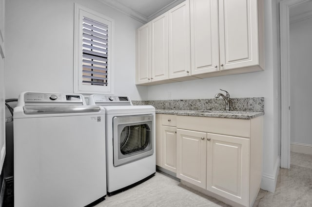 laundry area featuring separate washer and dryer, ornamental molding, and cabinet space