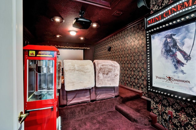 carpeted cinema room with crown molding and wallpapered walls