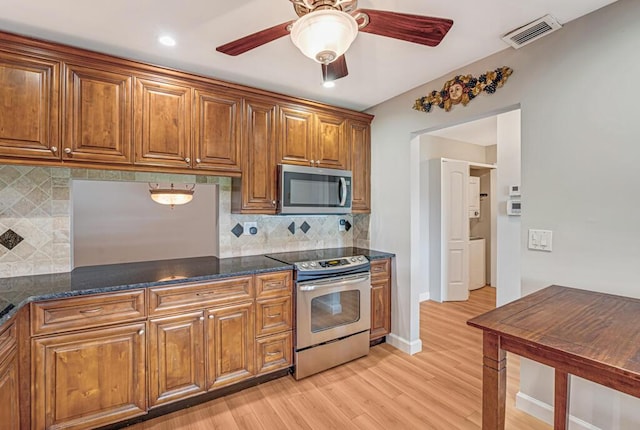 104 Lake Helen Dr, West Palm Beach, FL 33411 - kitchen with a ceiling fan, brown cabinetry, visible vents, stainless steel appliances, and light wood-type flooring