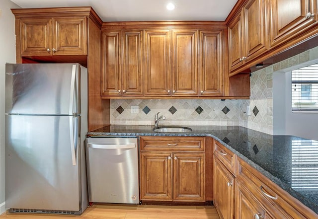 104 Lake Helen Dr, West Palm Beach, FL 33411 - kitchen featuring a sink, brown cabinetry, and appliances with stainless steel finishes