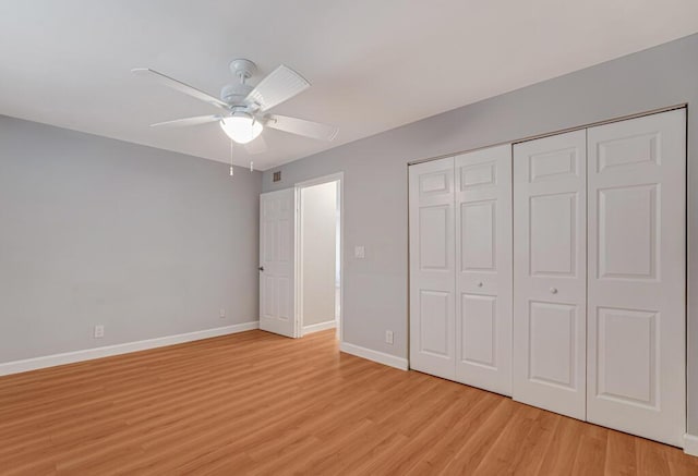 104 Lake Helen Dr, West Palm Beach, FL 33411 - unfurnished bedroom featuring baseboards, light wood finished floors, a closet, and a ceiling fan