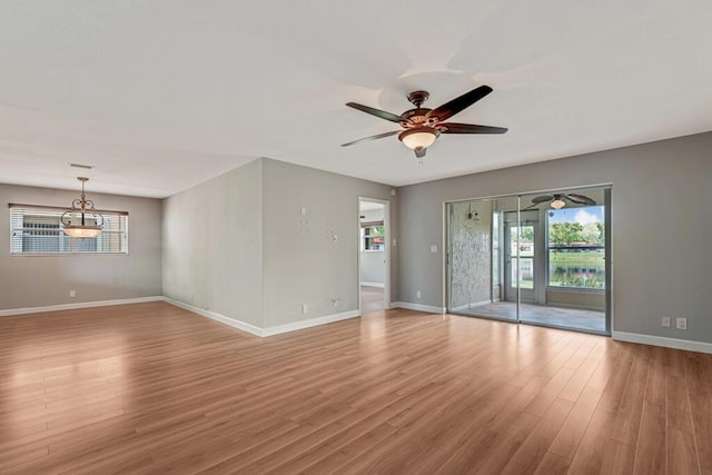 104 Lake Helen Dr, West Palm Beach, FL 33411 - kitchen featuring a ceiling fan, a sink, brown cabinetry, appliances with stainless steel finishes, and light wood-style floors