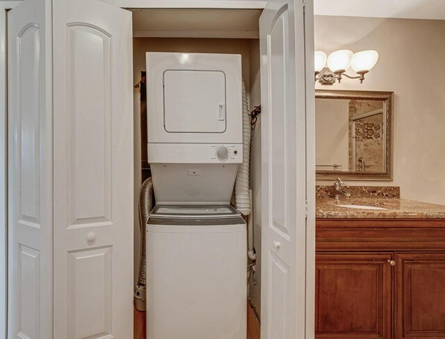 104 Lake Helen Dr, West Palm Beach, FL 33411 - clothes washing area with stacked washer and dryer, laundry area, and a sink