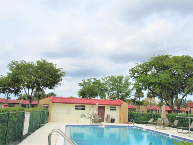 104 Lake Helen Dr, West Palm Beach, FL 33411 - community pool with a patio and fence