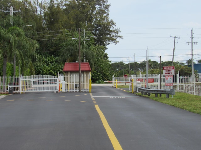 104 Lake Helen Dr, West Palm Beach, FL 33411 - view of road featuring a gate and a gated entry