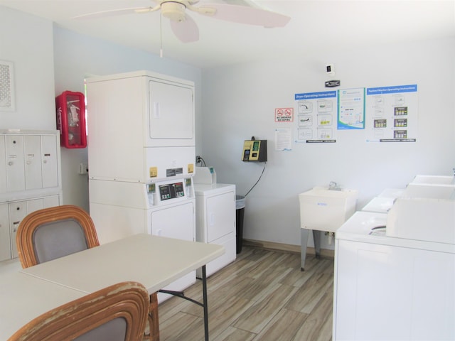 104 Lake Helen Dr, West Palm Beach, FL 33411 - shared laundry area featuring stacked washer and clothes dryer, light wood-style flooring, a ceiling fan, a sink, and baseboards