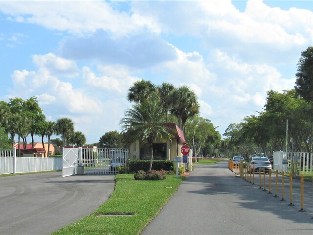 104 Lake Helen Dr, West Palm Beach, FL 33411 - view of road featuring traffic signs and a gated entry