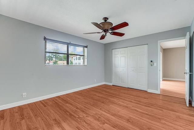 104 Lake Helen Dr, West Palm Beach, FL 33411 - unfurnished bedroom featuring light wood finished floors, a closet, baseboards, and a ceiling fan