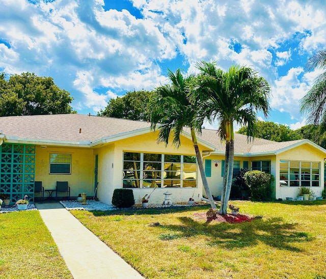 14280 Nesting Way Unit B, Delray Beach, FL 33484 - view of front facade with stucco siding and a front lawn
