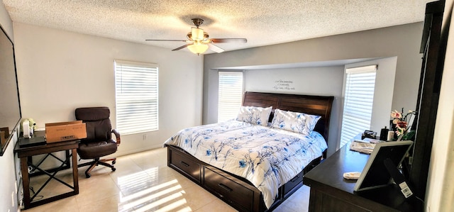 bedroom featuring light tile patterned floors, a textured ceiling, and ceiling fan