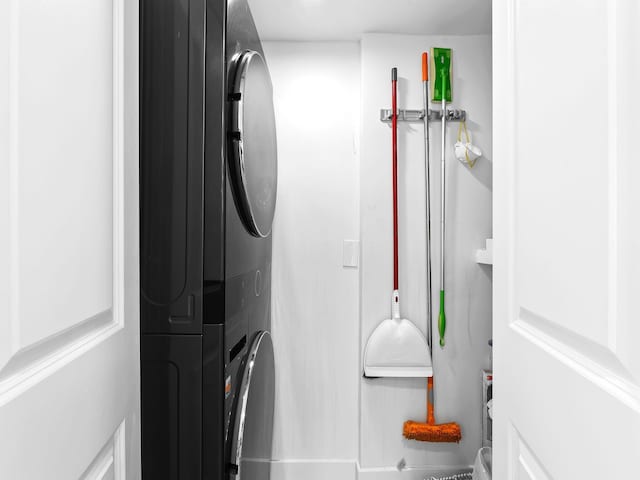 laundry area with stacked washing maching and dryer and laundry area