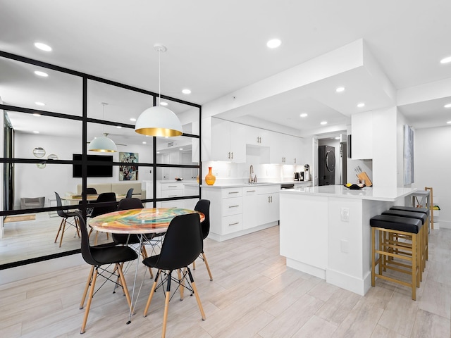 dining space with recessed lighting and light wood finished floors