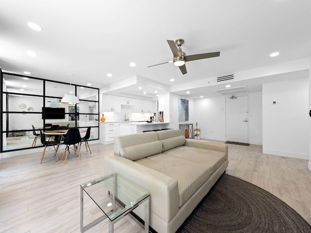 living room featuring light wood-type flooring, recessed lighting, ceiling fan, and visible vents