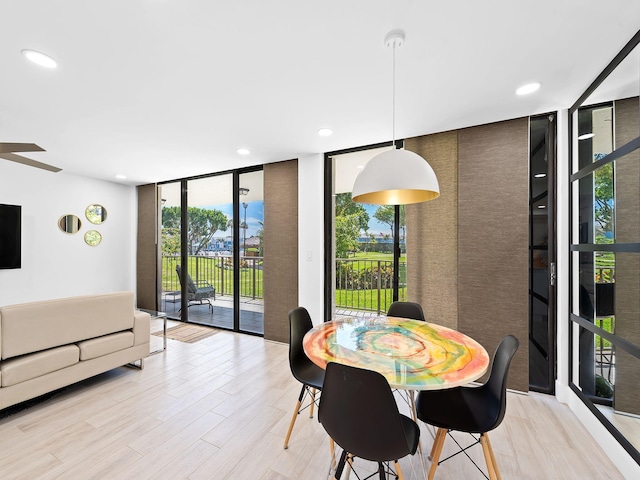 dining space with floor to ceiling windows, light wood-style flooring, recessed lighting, and a ceiling fan
