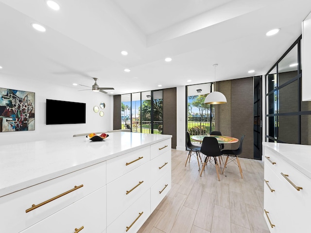 kitchen featuring modern cabinets, floor to ceiling windows, light countertops, and recessed lighting